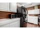 Kitchen with white cabinets, black appliances, and wood accents at 6255 E Ensenada St, Mesa, AZ 85205