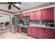 Modern kitchen with stainless steel appliances and red cabinetry at 6255 E Ensenada St, Mesa, AZ 85205