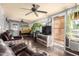 Spacious living room with brown leather couches and plants at 6255 E Ensenada St, Mesa, AZ 85205