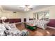 Bright living room featuring hardwood floors and floral couches at 6255 E Ensenada St, Mesa, AZ 85205