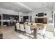 Open concept dining area with a long wooden table and modern kitchen in the background at 17213 E Morning Vista Ct, Rio Verde, AZ 85263