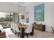 Bright dining room features a large wooden table with white chairs and modern light fixtures at 17213 E Morning Vista Ct, Rio Verde, AZ 85263