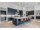 Modern kitchen with navy blue cabinets, a large island, and stainless steel appliances at 17213 E Morning Vista Ct, Rio Verde, AZ 85263