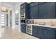 Modern kitchen with navy blue cabinets, beverage center, and white countertops at 17213 E Morning Vista Ct, Rio Verde, AZ 85263