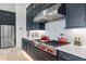 Modern kitchen with navy blue cabinets and a stainless steel range hood at 17213 E Morning Vista Ct, Rio Verde, AZ 85263