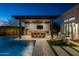 Modern outdoor kitchen and dining area adjacent to the pool at 17213 E Morning Vista Ct, Rio Verde, AZ 85263