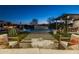 Relaxing patio furniture near a beautiful pool at dusk at 17213 E Morning Vista Ct, Rio Verde, AZ 85263