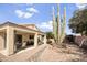 A covered patio enhances the property, complemented by desert landscaping and ample yard space at 17317 N Ponca Way, Surprise, AZ 85374