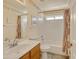 Neat bathroom with a single sink vanity, shower-tub combination, and fresh, neutral décor at 17317 N Ponca Way, Surprise, AZ 85374