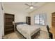 Cozy bedroom with neutral walls, tile floors, built-in shelving, and natural light at 17317 N Ponca Way, Surprise, AZ 85374