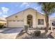 Inviting single-story home featuring a well-manicured front yard and an attached two-car garage at 17317 N Ponca Way, Surprise, AZ 85374