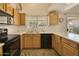 Well-lit kitchen with wood cabinetry, streamlined appliances, and a view of the backyard at 17317 N Ponca Way, Surprise, AZ 85374