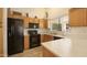 Functional kitchen with classic wood cabinets, modern appliances, and ample countertop space at 17317 N Ponca Way, Surprise, AZ 85374