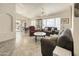 Open-concept living room filled with natural light, tile floors, and comfortable seating at 17317 N Ponca Way, Surprise, AZ 85374