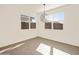 Bright dining area with large windows and a modern chandelier at 17709 W Southgate Ave, Goodyear, AZ 85338