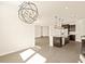 Sunlit dining area showcasing a contemporary chandelier and open floor plan at 17709 W Southgate Ave, Goodyear, AZ 85338