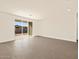 Bright living room with tile floors and sliding glass door leading to backyard at 17709 W Southgate Ave, Goodyear, AZ 85338