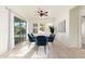 The dining room features natural light, a modern table, and stylish blue velvet chairs at 17763 W Hadley St, Goodyear, AZ 85338