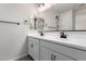 Bright bathroom featuring a double vanity, black hardware, modern fixtures, and ample counter space at 17868 W Blue Sky Dr, Surprise, AZ 85387