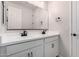 Bright bathroom featuring a double vanity, black hardware, modern fixtures, and tile floor at 17868 W Blue Sky Dr, Surprise, AZ 85387