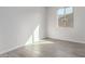 Bright bedroom featuring a window, tile flooring and neutral paint at 17868 W Blue Sky Dr, Surprise, AZ 85387