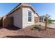 View of the home's exterior showcasing a two-car garage and desert landscaping at 17868 W Blue Sky Dr, Surprise, AZ 85387