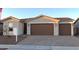 Charming home featuring a three-car garage and a tile roof at 17868 W Blue Sky Dr, Surprise, AZ 85387