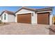 The home features a two-car garage and stylish brick driveway at 17868 W Blue Sky Dr, Surprise, AZ 85387