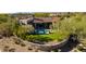 Luxury estate with pool and manicured lawn, stone wall at 19198 N 95Th Pl, Scottsdale, AZ 85255