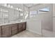 Modern bathroom with a double vanity, tiled shower, and natural light at 19341 W San Juan Ave, Litchfield Park, AZ 85340