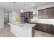 Contemporary kitchen featuring granite countertops, a stainless steel vent hood and dark cabinetry at 19341 W San Juan Ave, Litchfield Park, AZ 85340