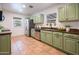 Modern kitchen with green cabinets and tiled floor at 2021 W Osborn Rd, Phoenix, AZ 85015