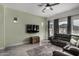 Bright living room with gray sofa and large TV at 22811 E Stacey Rd, Queen Creek, AZ 85142