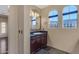 Bathroom with dark granite vanity and arched windows at 2322 E Samantha Way, Phoenix, AZ 85042