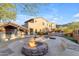 Stone fire pit with seating and pool view at 2322 E Samantha Way, Phoenix, AZ 85042