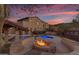 Circular fire pit with seating and pool views at 2322 E Samantha Way, Phoenix, AZ 85042