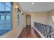 Upper hallway with hardwood floors, arched alcove, and wrought iron railing at 2322 E Samantha Way, Phoenix, AZ 85042