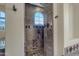 Walk-in shower with stone tile and arched window at 2322 E Samantha Way, Phoenix, AZ 85042