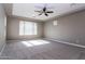 Bright bedroom featuring a ceiling fan and large window with blinds at 3943 E Canyon Pl, Chandler, AZ 85249