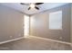 Spacious bedroom with ceiling fan and door to hallway at 3943 E Canyon Pl, Chandler, AZ 85249