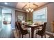 Bright dining room features a large table, chandelier, and hardwood floors at 3943 E Canyon Pl, Chandler, AZ 85249