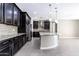 Modern kitchen with dark cabinetry, granite countertops, and stainless steel appliances at 3943 E Canyon Pl, Chandler, AZ 85249