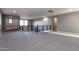 Spacious loft area with a modern staircase and neutral carpeting at 3943 E Canyon Pl, Chandler, AZ 85249