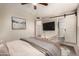 Bedroom featuring a large TV, barn doors, and neutral decor at 4329 W Sierra St, Glendale, AZ 85304