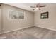 Bright bedroom featuring neutral paint, carpet flooring, a ceiling fan, and a window offering natural light at 4329 W Sierra St, Glendale, AZ 85304