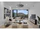 Spacious living room featuring a sectional sofa and sliding glass doors leading to a balcony at 4748 E White Dr, Paradise Valley, AZ 85253