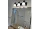 Bright bathroom featuring granite countertops, a large mirror, vanity lighting, and white cabinets at 7143 E Canyon Wren Dr, Gold Canyon, AZ 85118