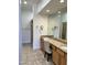 Bathroom boasts double sinks, granite countertops, a tile floor, and framed mirrors at 7143 E Canyon Wren Dr, Gold Canyon, AZ 85118