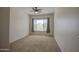 Bright bedroom with neutral carpet, large window, and plenty of natural light at 7143 E Canyon Wren Dr, Gold Canyon, AZ 85118