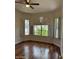 Bright bedroom featuring wood floors, a ceiling fan and shuttered windows with plenty of natural light at 7143 E Canyon Wren Dr, Gold Canyon, AZ 85118